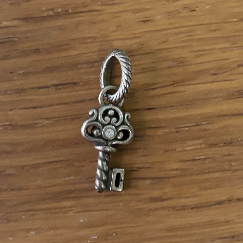 Brighton retired silver key charm featuring intricate details